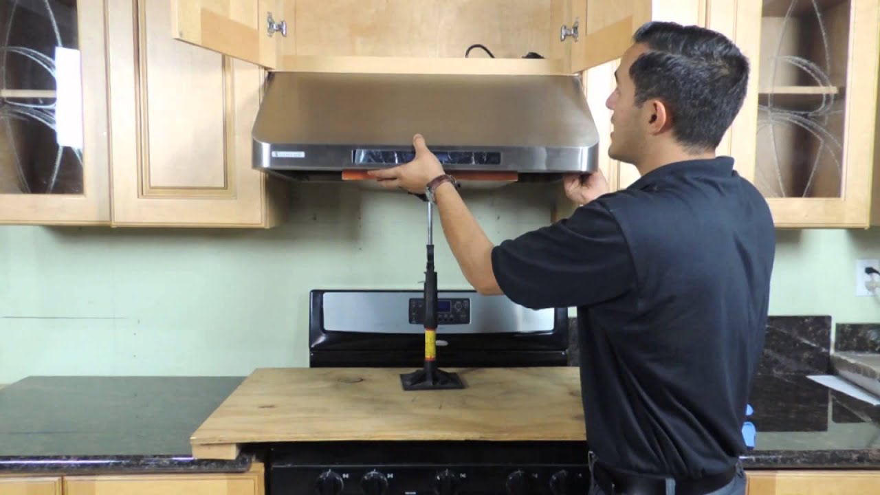 Kitchen hood installer working on commercial extraction system in Bishop's Stortford